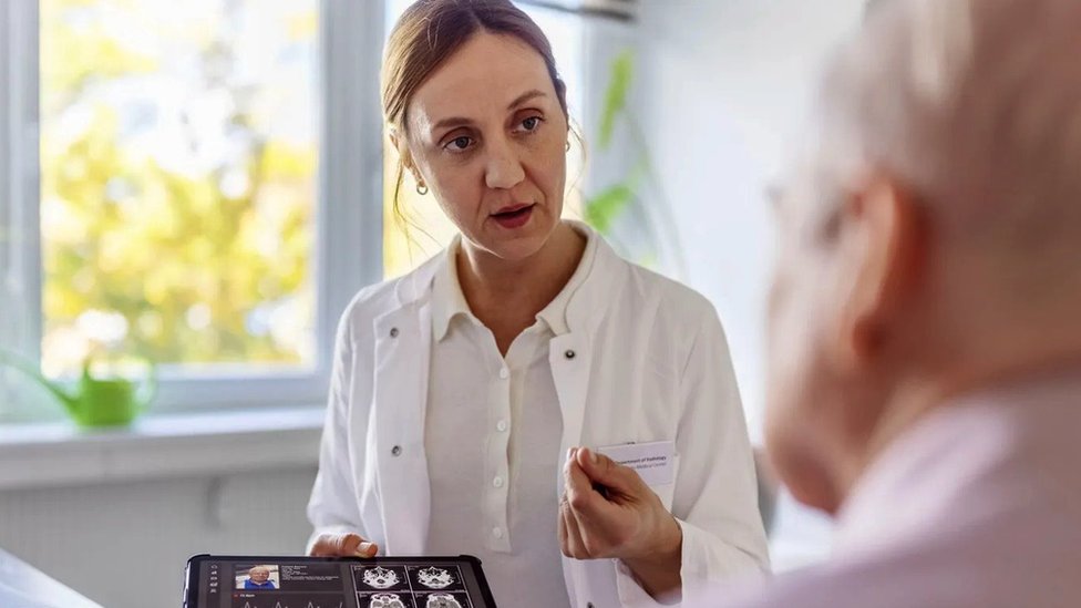 A doctor showing scan results to a patient