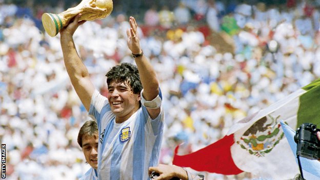 Diego Maradona holds up the World Cup trophy