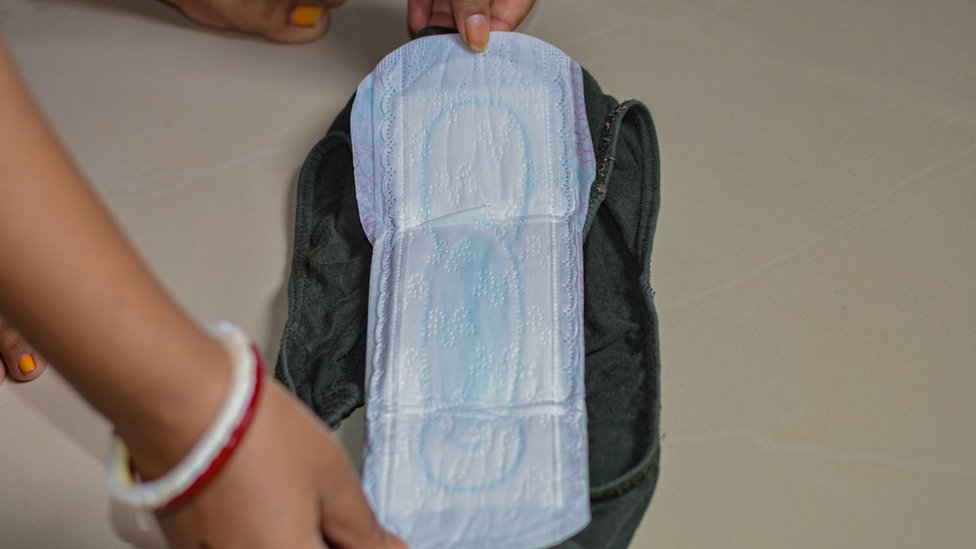 A sanitary pad being held open