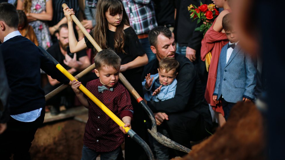 Christina Langford's husband and children at her funeral.