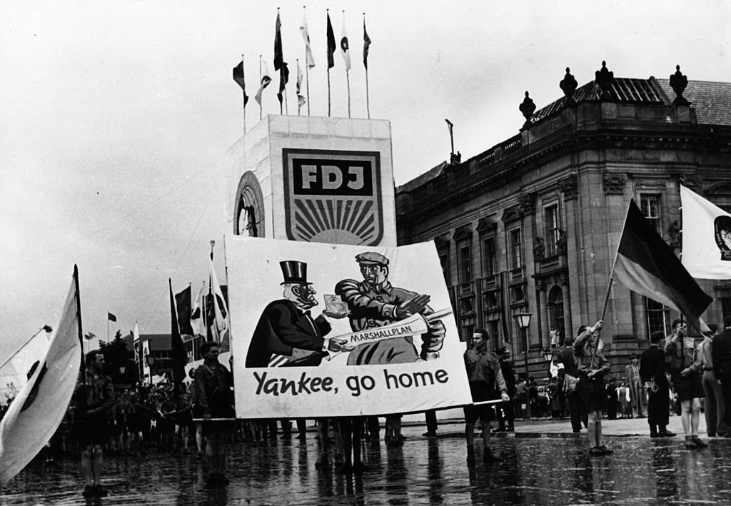 Pancartas con el lema "Yankee, vete a casa" que llevan los manifestantes durante un mitin juvenil de Alemania Oriental.
