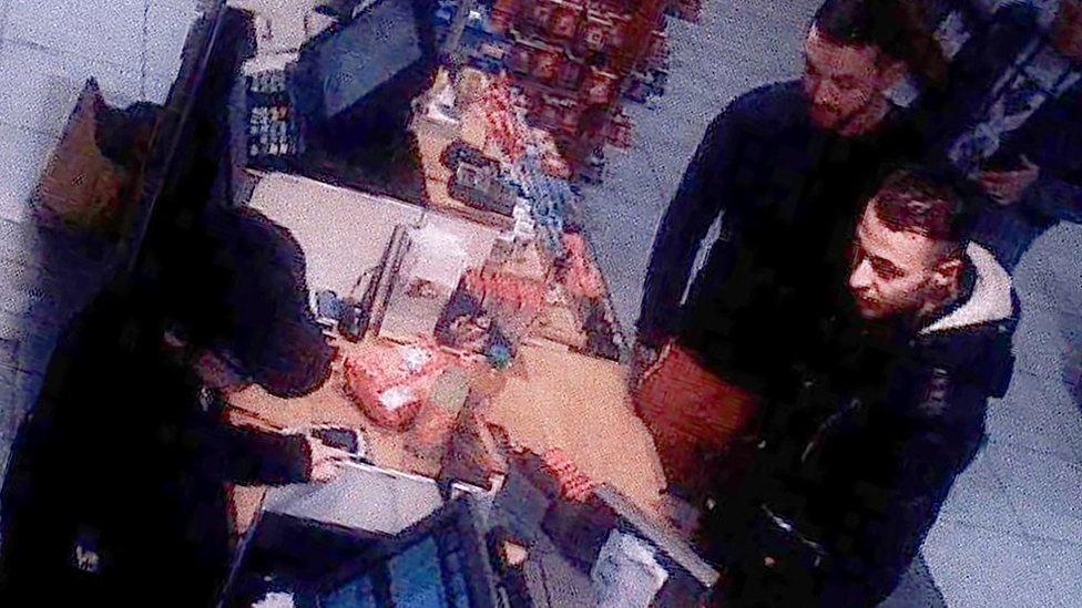 This video image taken from a CCTV camera at a petrol station in Ressons, North of Paris, on November 11, 2015 shows Salah Abdeslam (R) and Mohammed Abrini (C) buying goods.