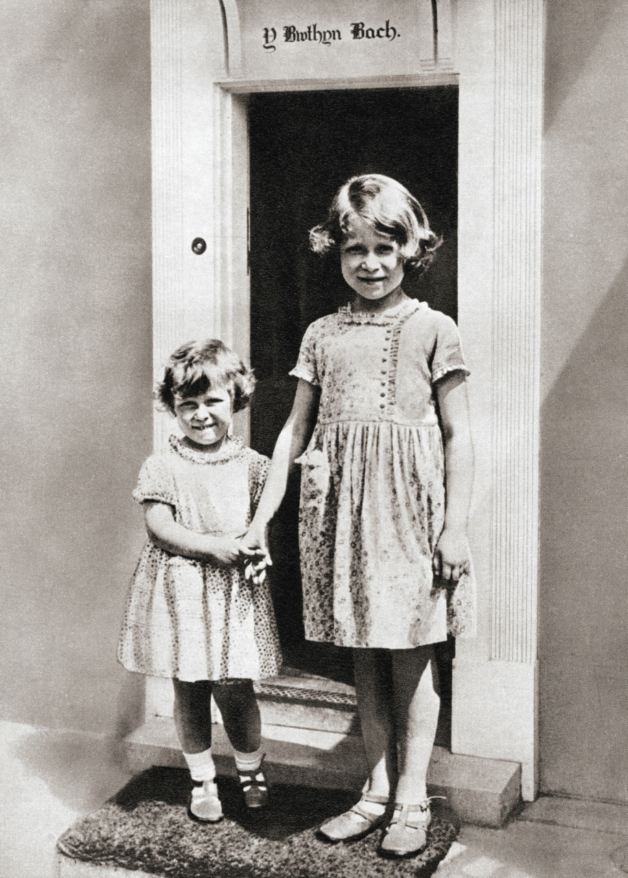 Princess Elizabeth, right, and her sister Princess Margaret in 1933 at Y Bwthyn Bach or The Little House, situated in the garden of the Royal Lodge, Windsor Great Park, Berkshire, England.