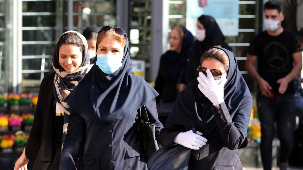 Iranian women wearing face masks and protective gloves walk in a street, in Tehran, Iran, 14 June 2020