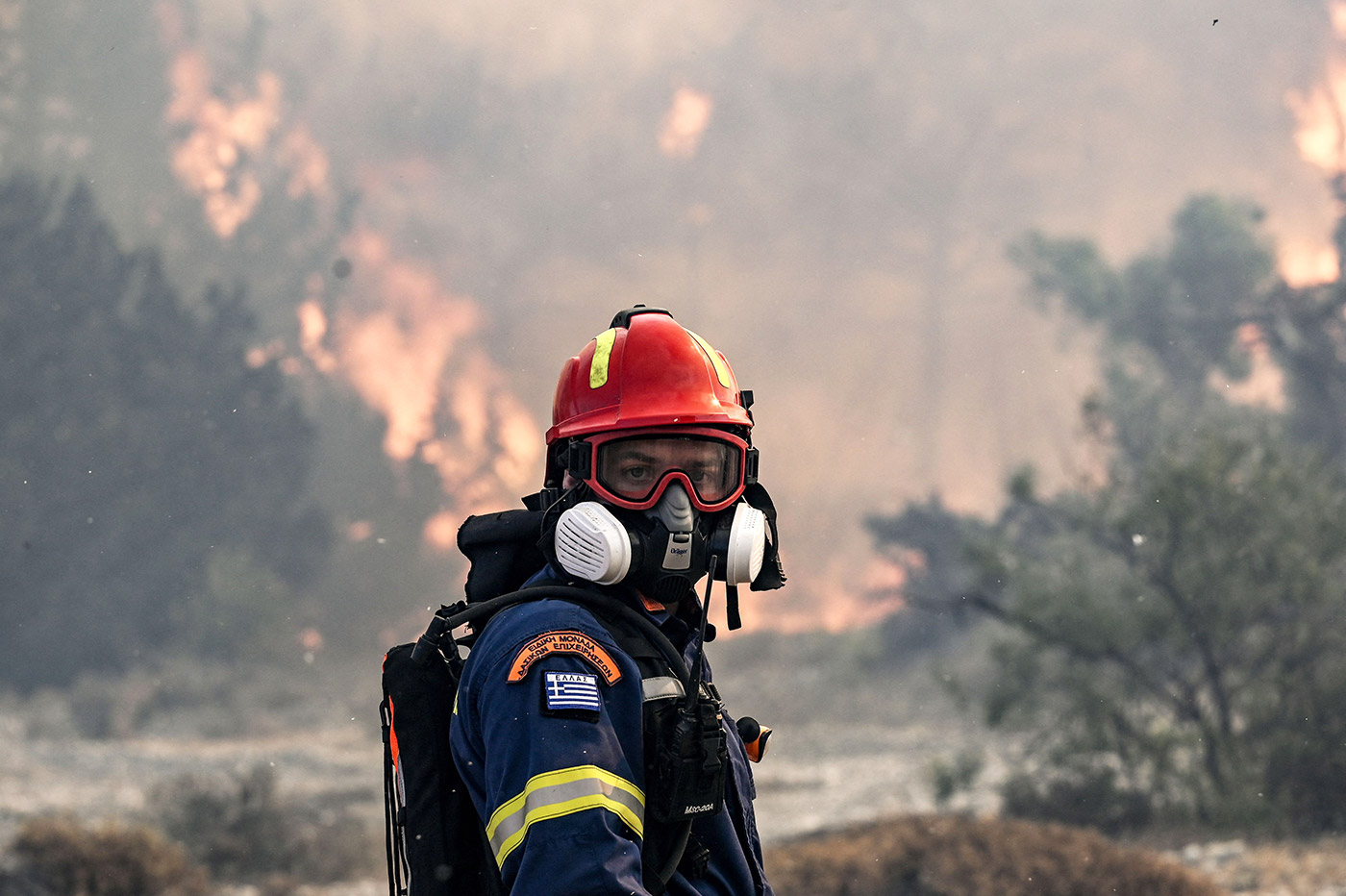 A firefighter looks on during a fire near the village of Vati, just north of the coastal town of Gennadi, in the southern part of the Greek island of Rhodes - 25 July 2023