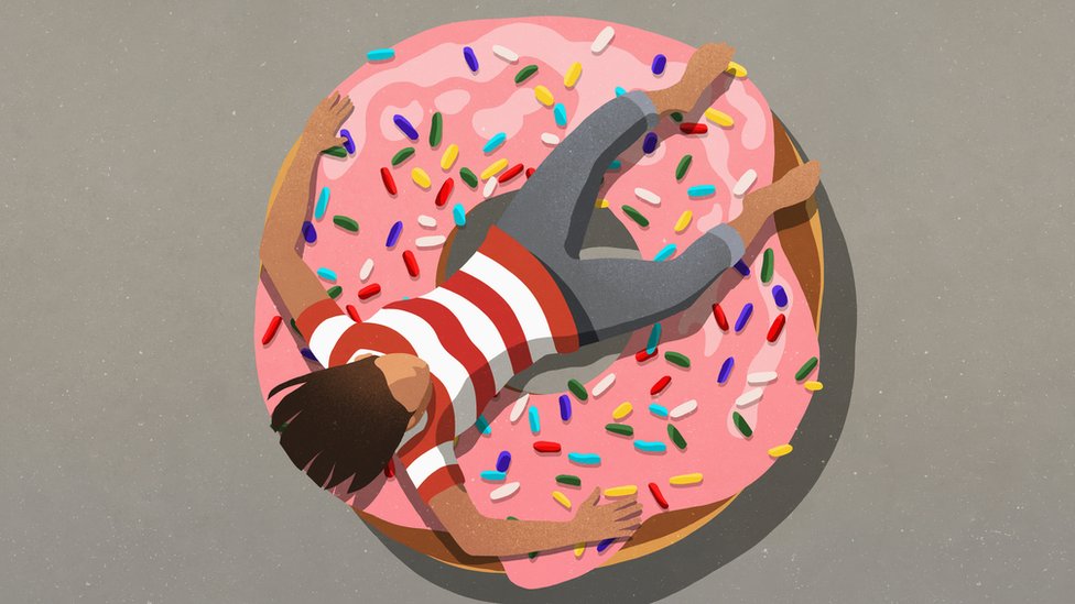 Person resting over a giant donut