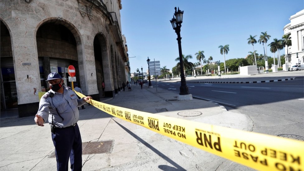 A police officer guards the areas surrounding the Capitol in Havana after anti-government unrest