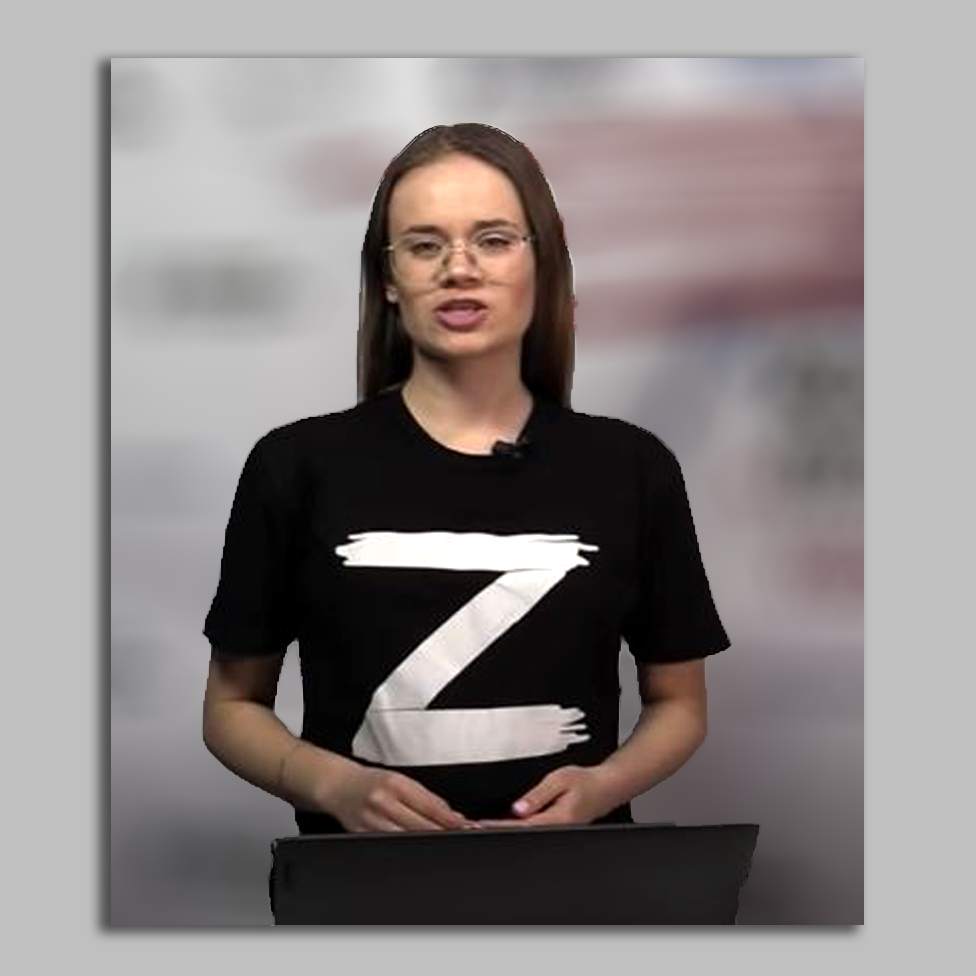 Female presenter wearing black t-shirt bearing the letter "Z"