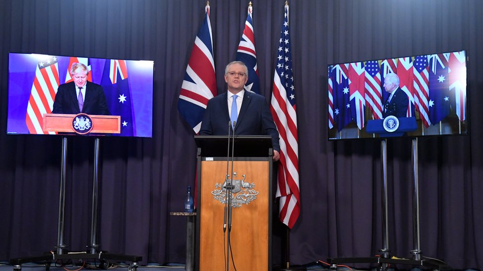 Scott Morrison (centre) speaks in a joint virtual press conference with his US and UK counterparts in announcing the Aukus security pact.
