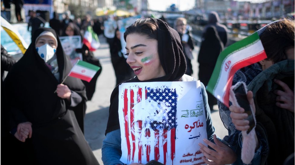Woman holds anti-US placard in Tehran (11/02/20)