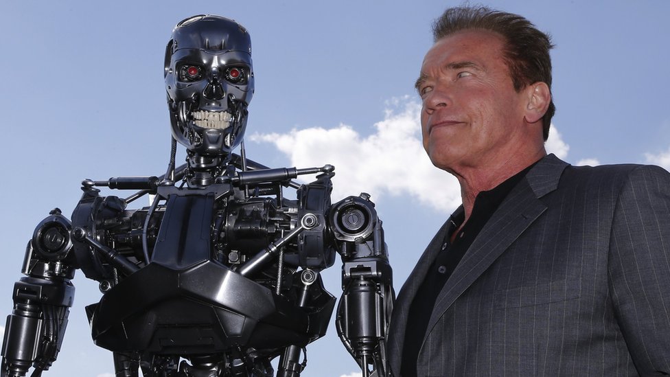 US actor and former governor of California Arnold Schwarzenegger poses with the Terminator animatronics robot during a photo call for the film Terminator Genisys on 19 June 2015 in Paris