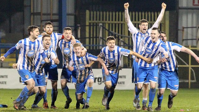 Coleraine players celebrate a penalty shootout victory over Ballinamallard