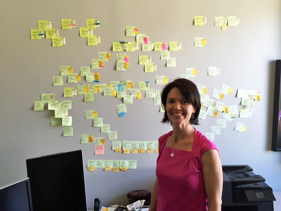 Genealogist Michelle Trostler in front of the 'wall of stickies' she assembled for the case