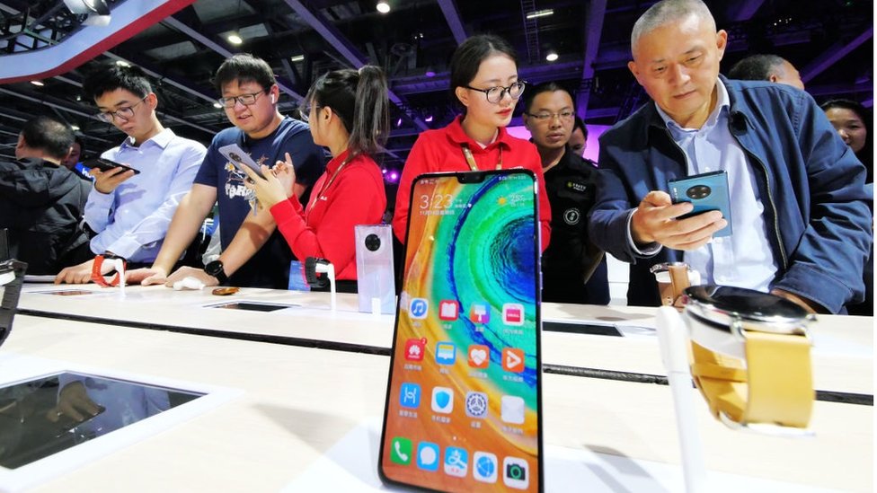 People try out 5G mobile phones at Huawei booth during China Mobile Global Partners Conference 2019 at Poly World Trade Center Expo on November 14, 2019 in Guangzhou, Guangdong Province of China.