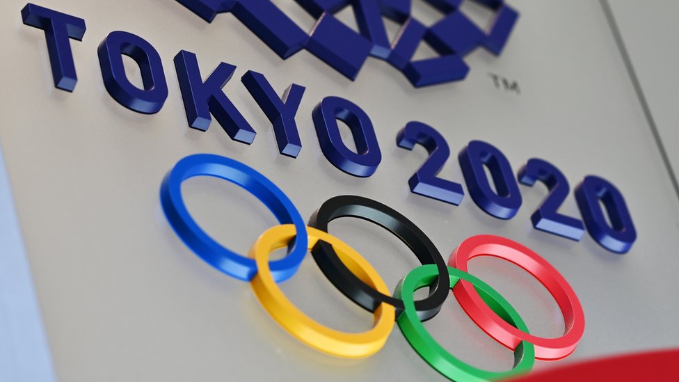 Олимпийские кольца и логотип Токио-2020 рельефно изображены на стене