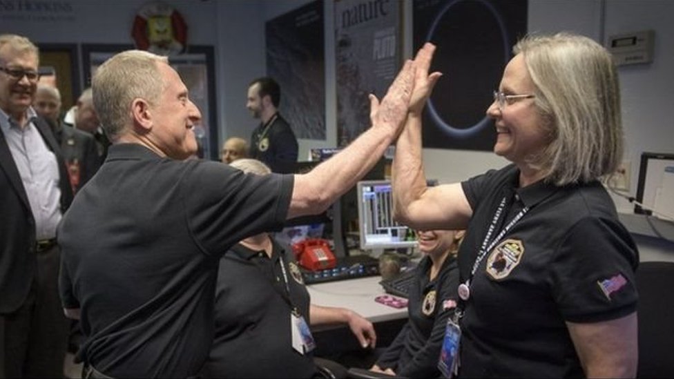 Alan Stern y Alice Bowman celebran con un gesto la llegada de las primeras señales de New Horizons