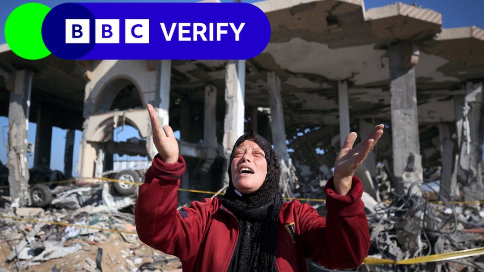 A Palestinian woman in front of a destroyed building in the Al-Maghazi refugee camp in the central Gaza Strip on January 16, 2024,