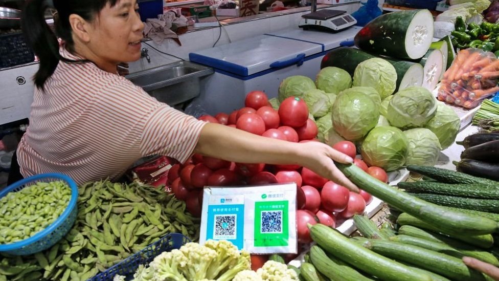 A food stall in china with QR codes for users of WeChat to pay by scanning it with their devices