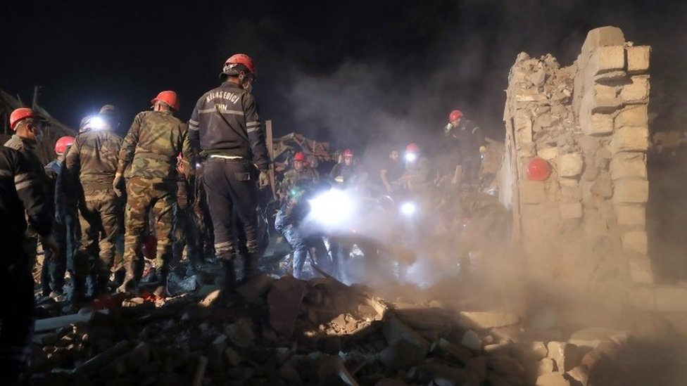 Rescue workers at the scene of damage in the Azerbaijani city of Ganja