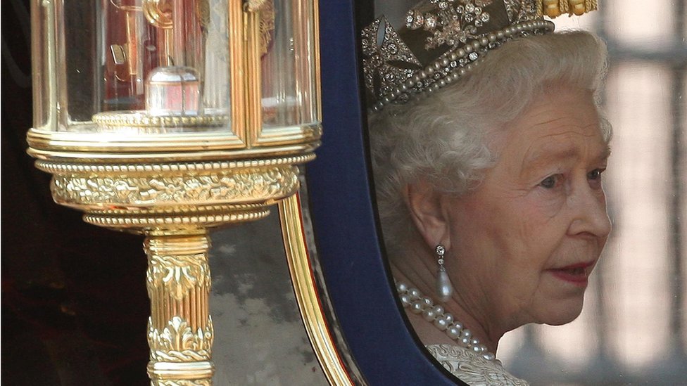 Queen Elizabeth II looking out the window of her carriage after the State Opening of Parliament