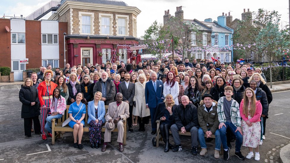 Prince Charles and Camilla, Duchess of Cornwall pose for a group photo with the cast and crew during a visit to the set of EastEnders at the BBC studios in Elstree,