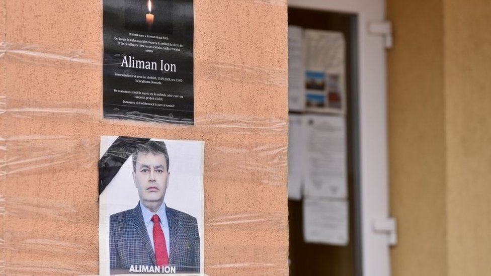 An obituary photo of former mayor Ion Aliman is taped on to the walls of the city hall in Deveselu, southern Romania, September 28, 2020