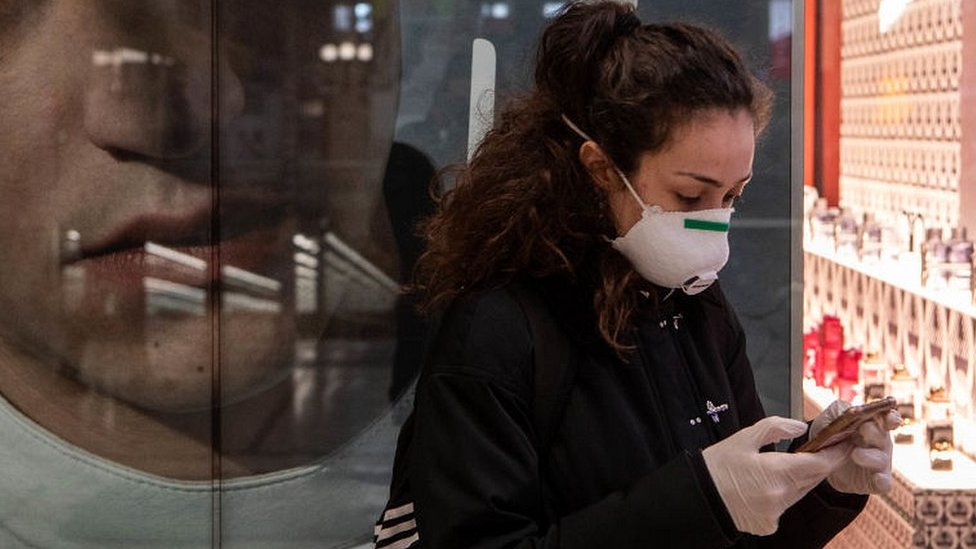 Woman checking her phone in Milan