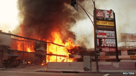 A shopping centre in Korea Town, Los Angeles, burning during the riots, 1 May 1992