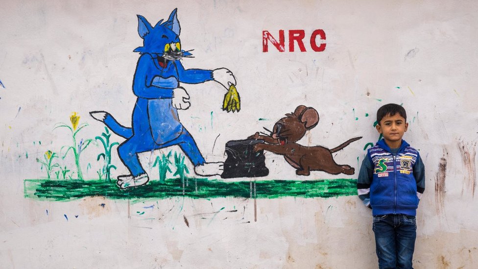 Lukisan Tom dan Jerry terlihat di kamp pengungsi di Domiz, Irak, tahun 2014. NRC di dinding itu singkatan dari Norwegian Refugee Council.