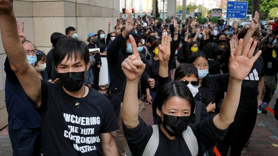 Protesters gesture outside West Kowloon Magistrates Court, where pro-democracy activists face charges related to national security, in Hong Kong