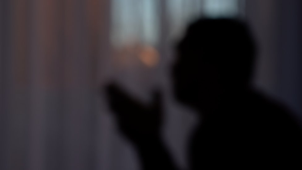 The blurred silhouette of a man