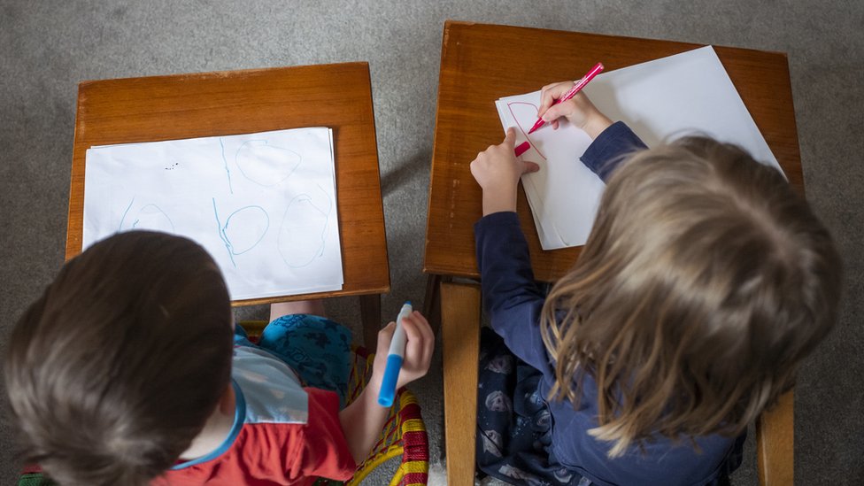 Children, Charlotte Rose, 5 and Alexander James, 3, practice their school work as home schooling continues on April 01, 2020 in Manchester, United Kingdom