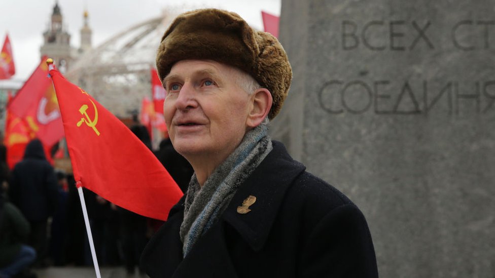 An old man with a Soviet flag