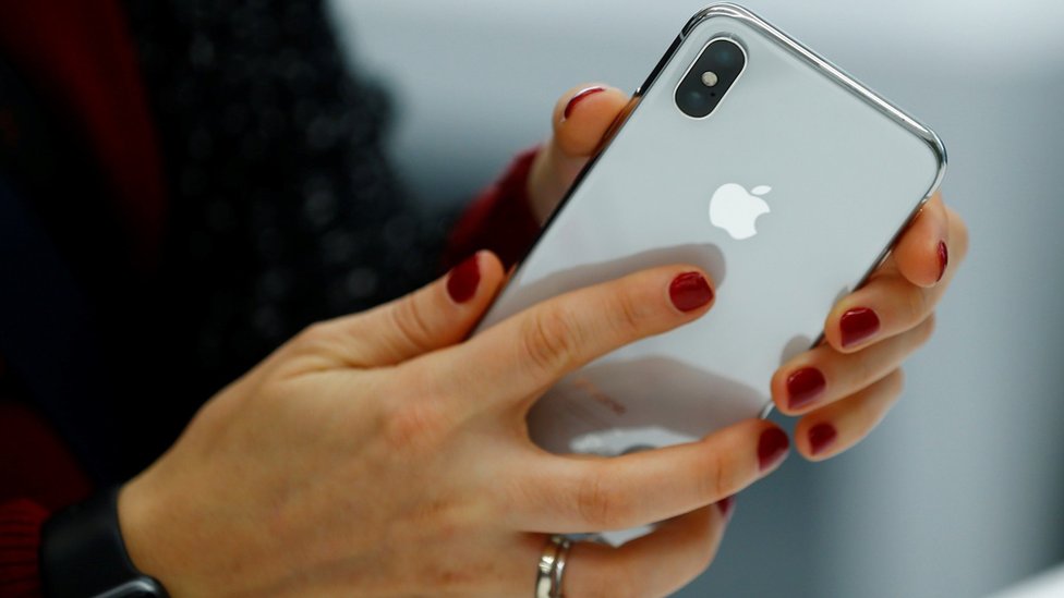Una persona sosteniendo un teléfono de la marca Apple.