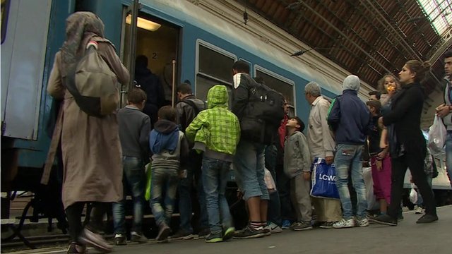 Migrants board a train in Budapest