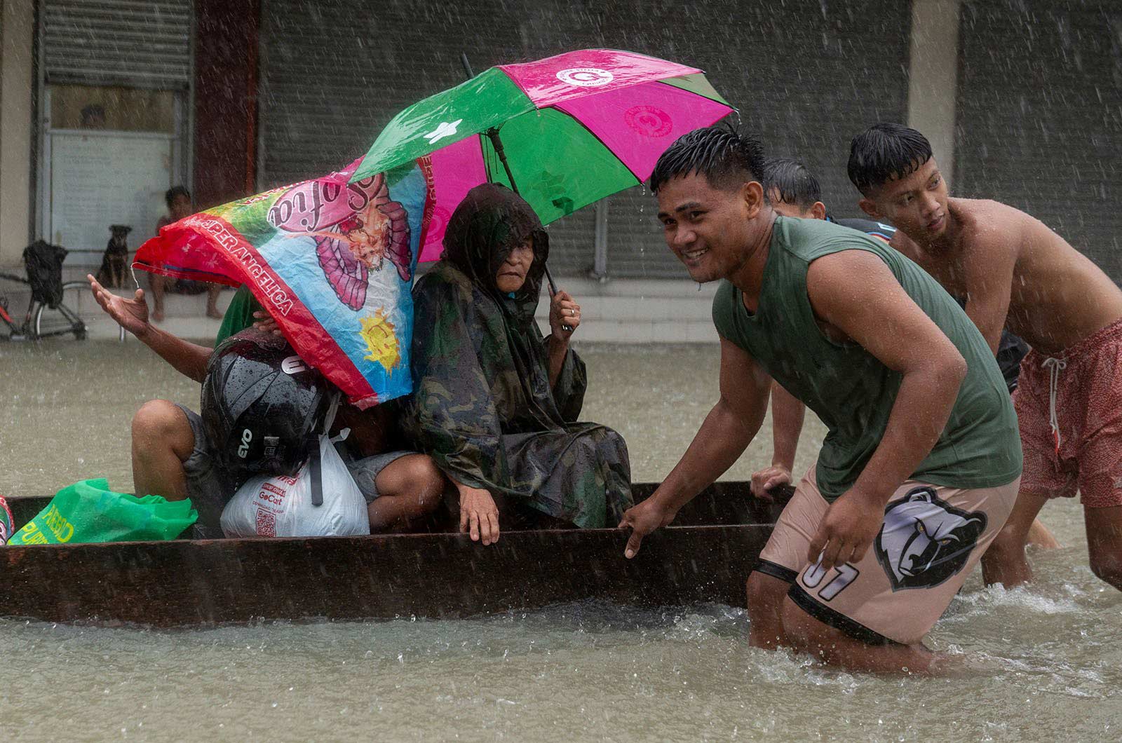 People are pushed through a street in Balagtas, Philippines, on a makeshift boat following monsoon rains and Typhoon Doksuri - 29 July, 2023.