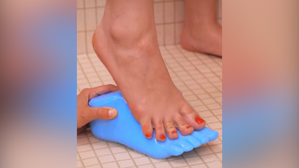 A foot rubbing along soap