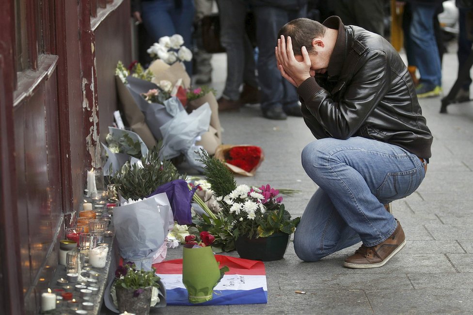 Čovek odaje počast žrtvama ispred restorana "Le Karilion", jutro posle napada u Parizu (14. novembar 2015)