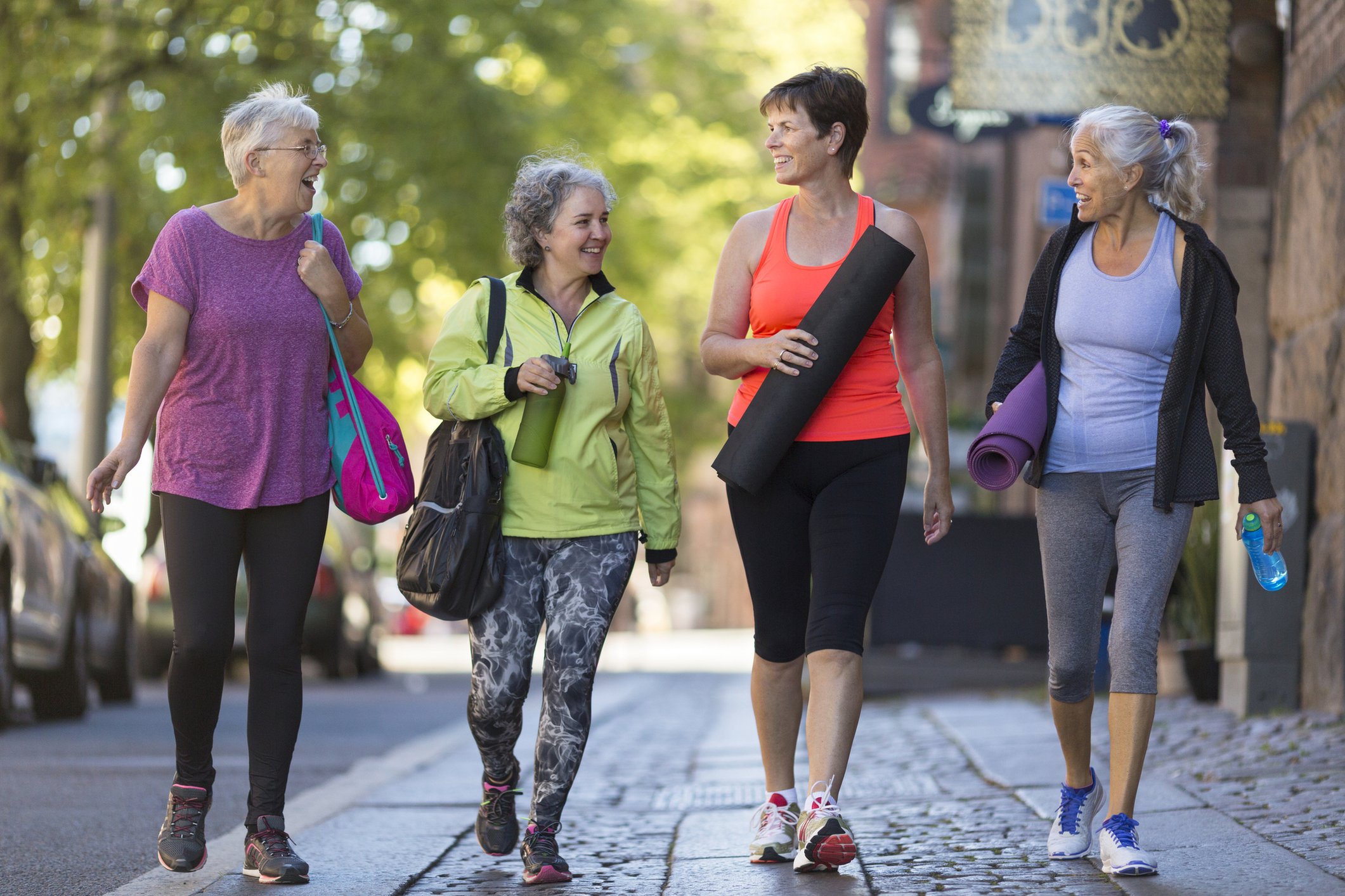 Cuatro mujeres juntas que van a hacer ejercicio.