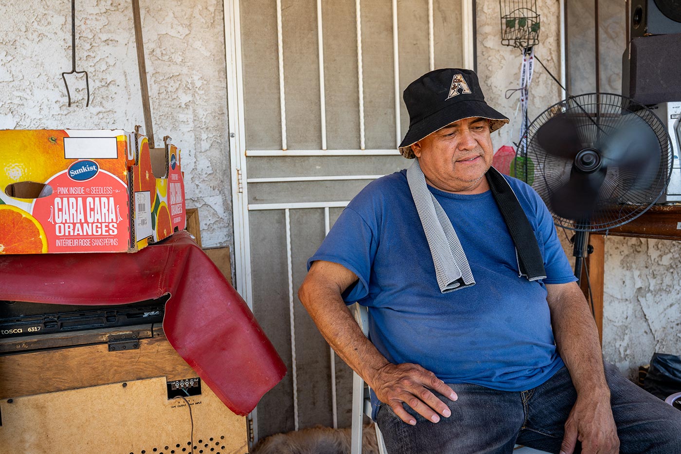 A local keeps cool on his porch ahead of his air conditioning unit installation during a heat wave in Phoenix, Arizona - 15 July 2023