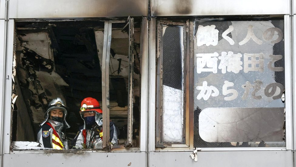 Firefighters at a building where a fire broke out in Osaka, western Japan, 17 December 2021