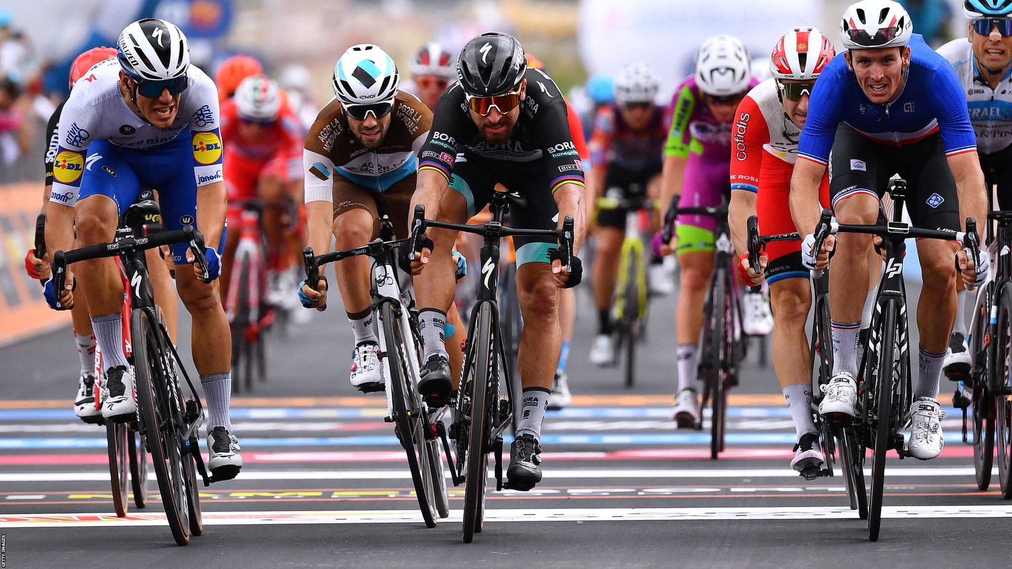 Giro d’Italia rider taken to hospital with multiple injuries after ‘helicopter blows barriers into road’