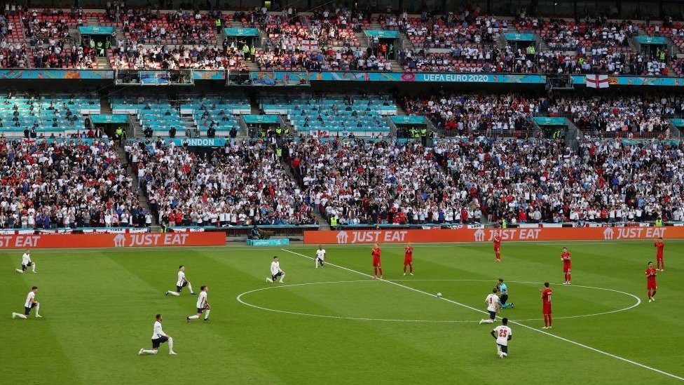 England players kneeling down ahead of the game against Denmark