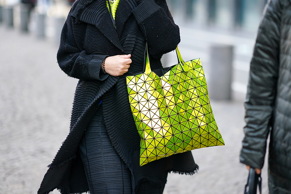Gost na reviji nosi žutu torbu Bao Boa na Nedelji mode u Parizu 2020. godine. Prepoznatljiva po malim trouglovima od smole, postala je toliko popularna da su tržiše preplavile razne kopije