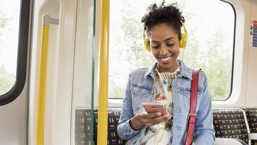 Mujer escuchando música en el metro