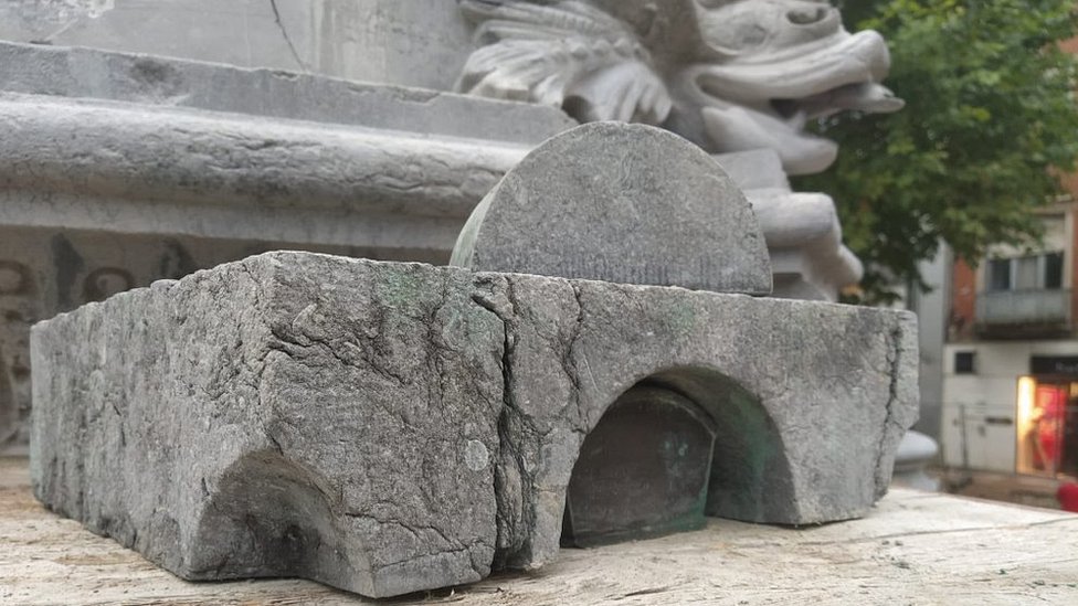 Hollowed-out stone from fountain with casket