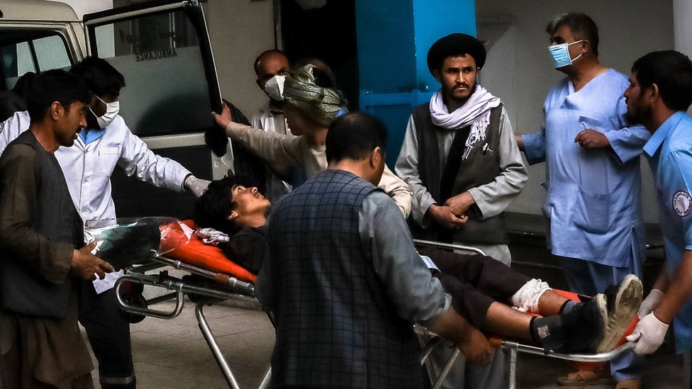 People carry an injured man into a hospital after an explosion in downtown Kabul, Afghanistan, 08 May 2021.