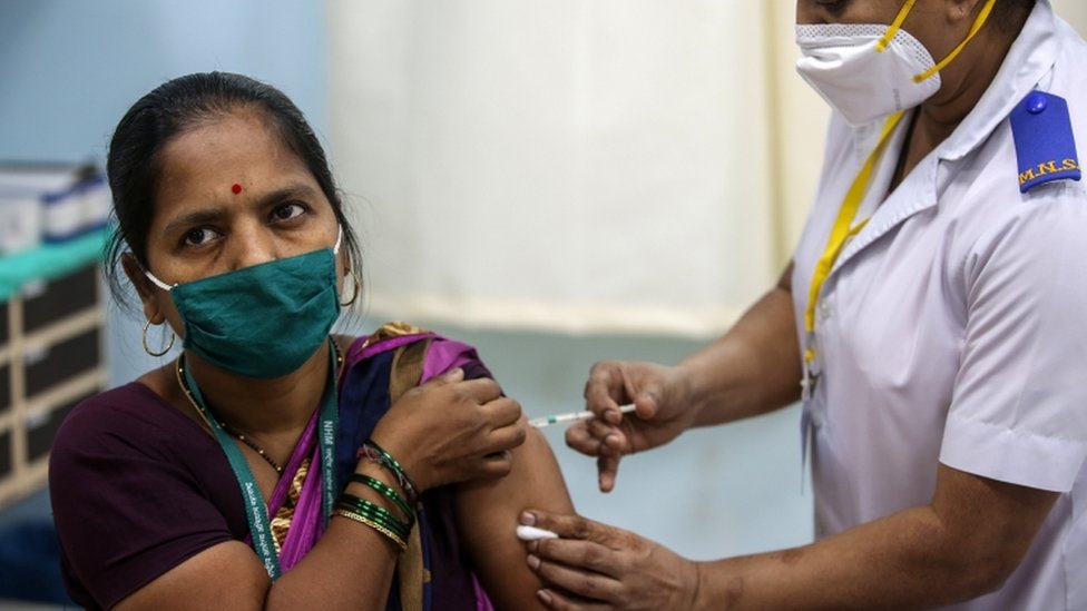 A woman gets a vaccines at Rajawadi Hospital in Mumbai, India