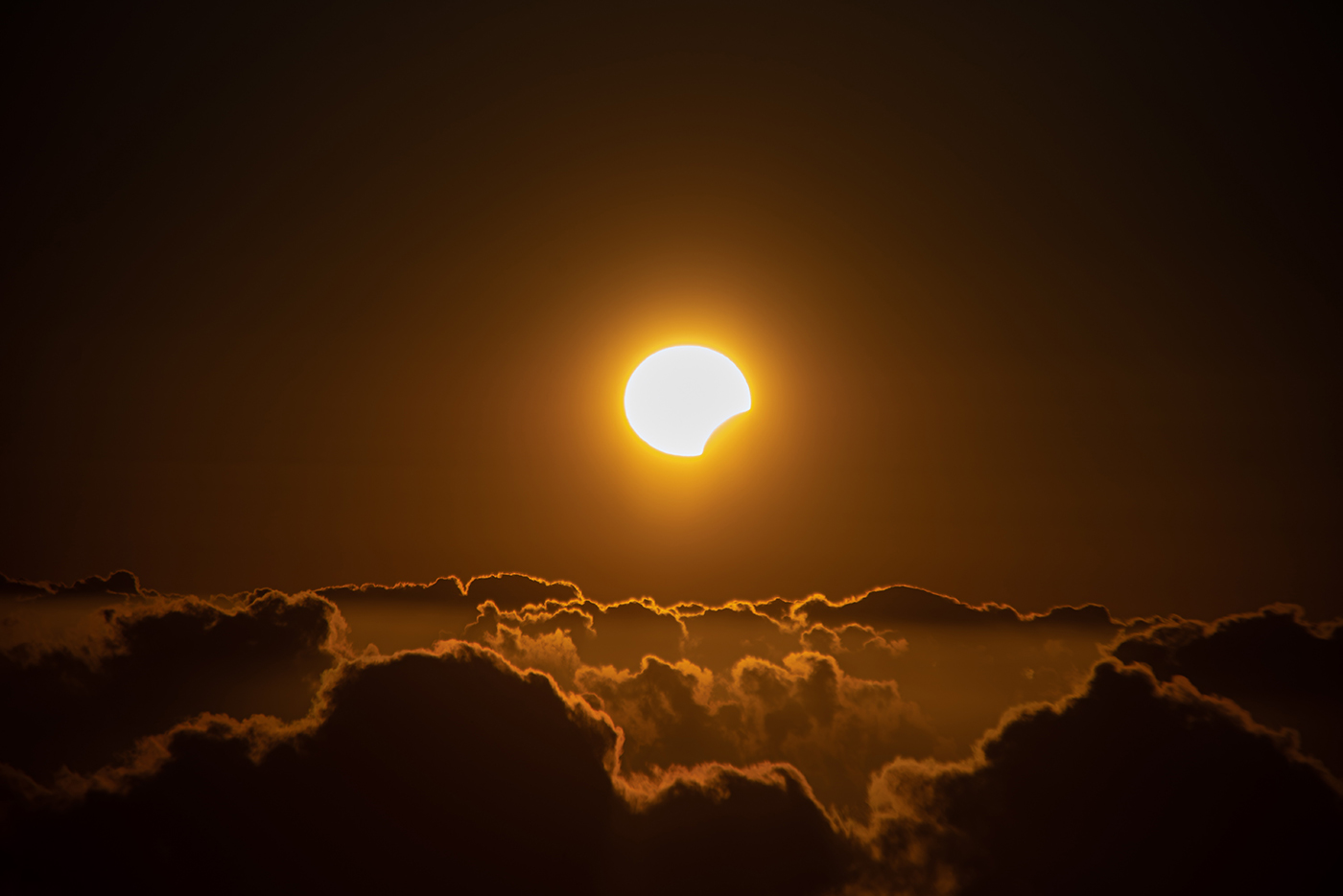 A view on the partial solar eclipse seen over the sea of clouds in Garafia, Canary Islands, Spain - 8 April 2024 (Miguel Calero/Shutterstock)