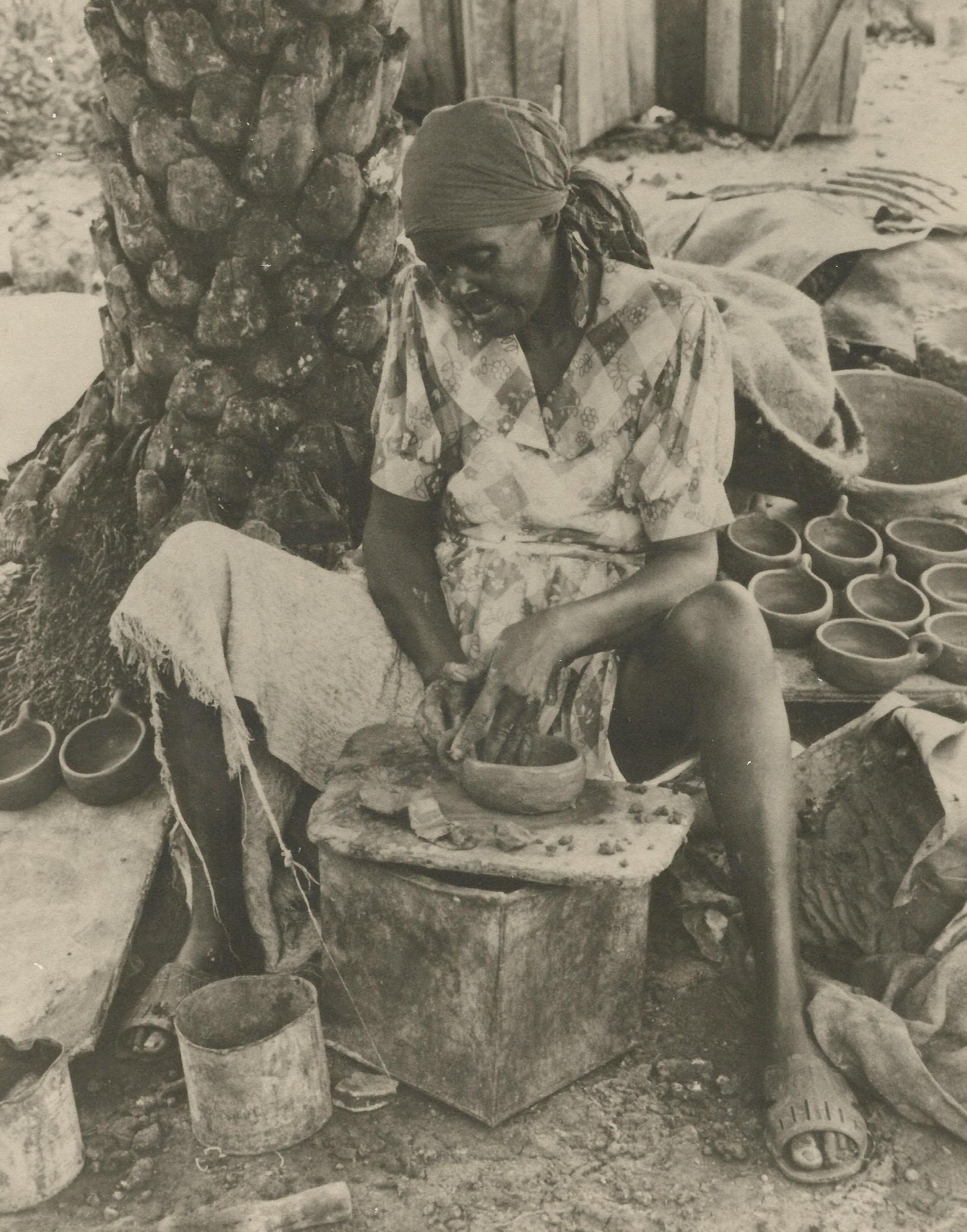 Historical photo from the National Museum of Antigua and Barbuda of a woman making traditional pottery